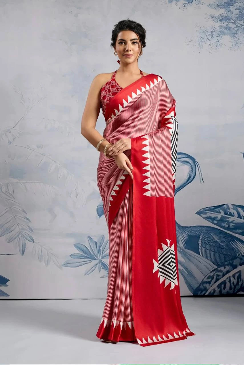 Woman wearing a red and white saree with a geometric pattern against a decorative background
